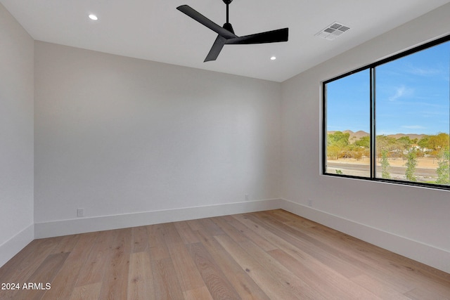 unfurnished room with ceiling fan and light wood-type flooring