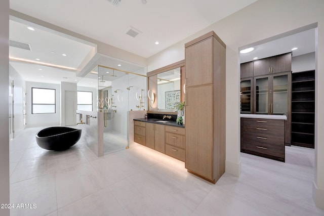 bathroom featuring vanity, tile patterned floors, and walk in shower