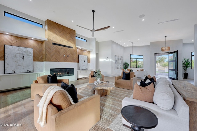 living room featuring ceiling fan and light wood-type flooring