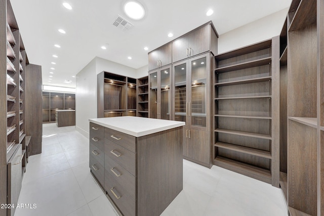 walk in closet with light tile patterned floors