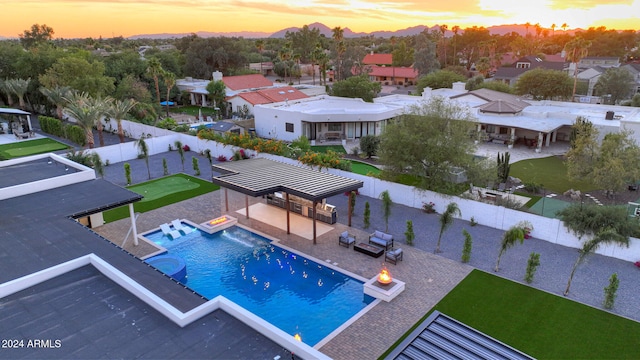 pool at dusk with a gazebo and a patio area