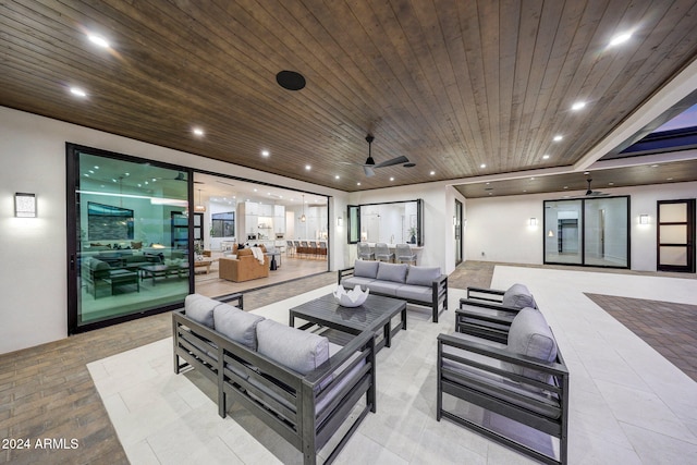 tiled living room featuring wood ceiling and ceiling fan