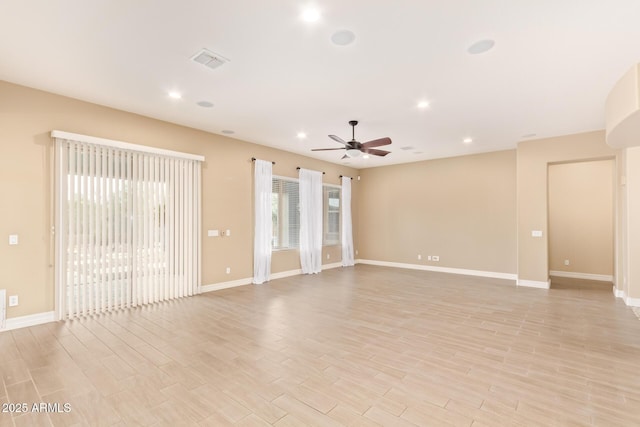 spare room with light wood-type flooring and ceiling fan