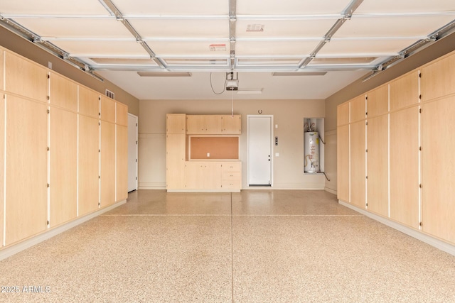 garage featuring gas water heater and a garage door opener