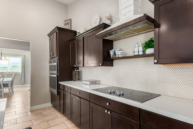 kitchen with dark brown cabinets, black electric stovetop, decorative backsplash, and double oven