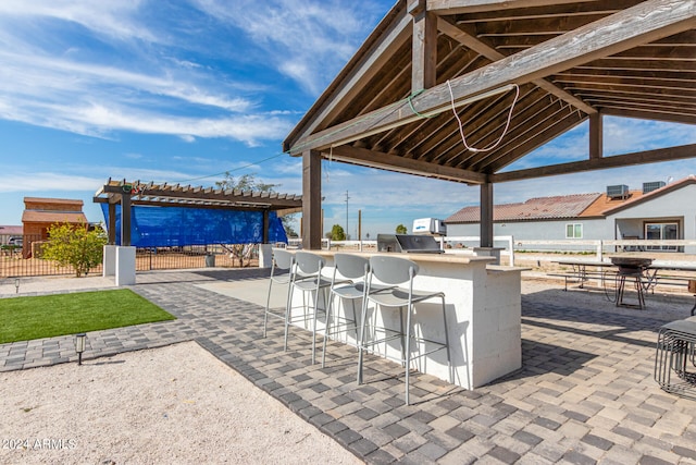 view of patio / terrace with an outdoor bar and an outdoor kitchen