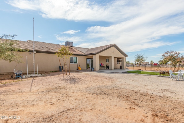 back of property with a patio area and central AC