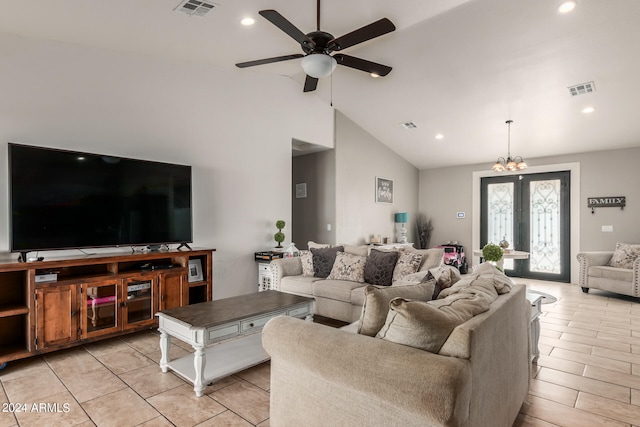 living room featuring ceiling fan with notable chandelier, light hardwood / wood-style flooring, french doors, and high vaulted ceiling