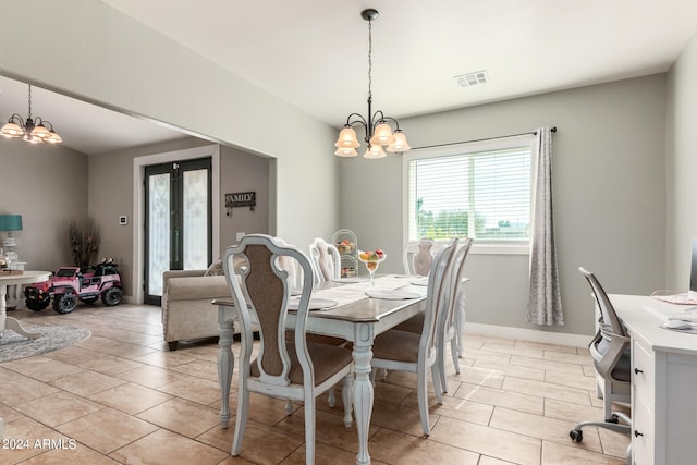 dining area with a notable chandelier