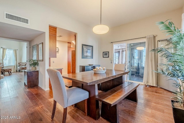 dining space with wood-type flooring