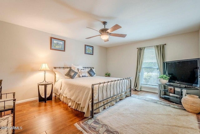 bedroom with ceiling fan and wood-type flooring