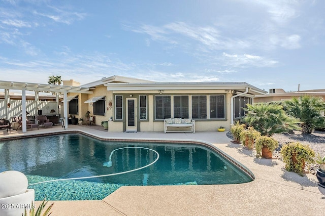 view of swimming pool with a sunroom, a pergola, and a patio