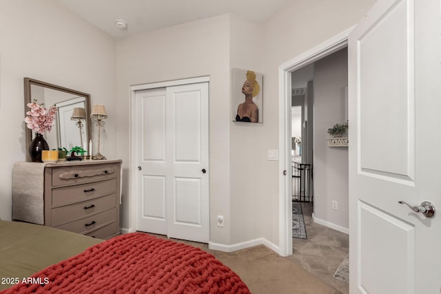 bedroom with light colored carpet and a closet