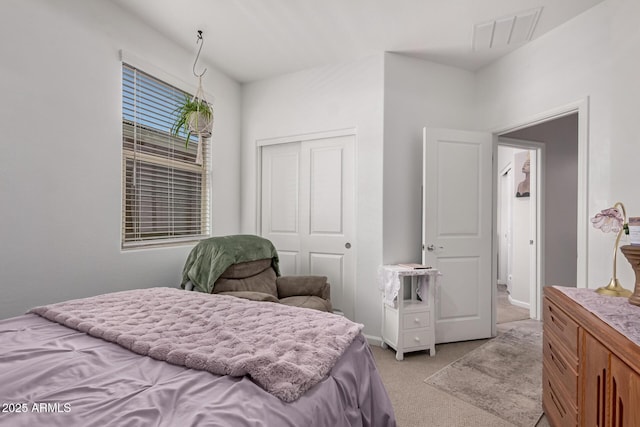 bedroom with light carpet and a closet