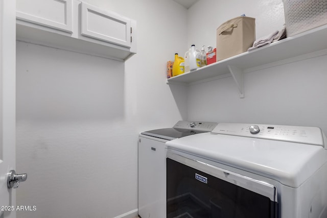 washroom featuring cabinets and washing machine and dryer