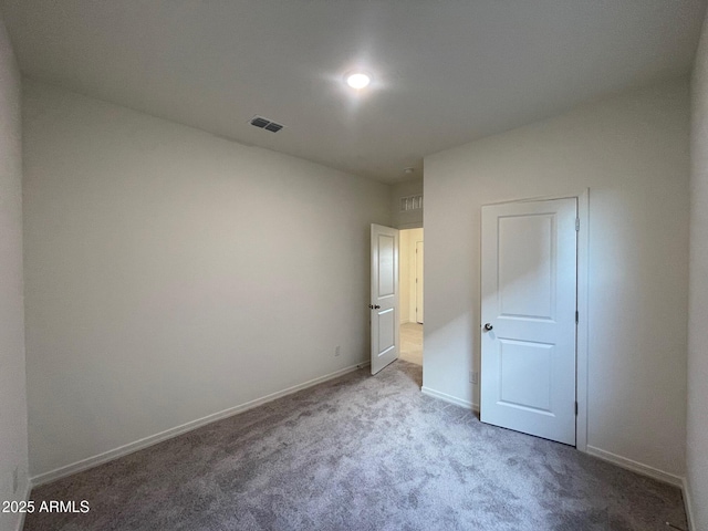 unfurnished bedroom featuring baseboards, visible vents, and carpet flooring