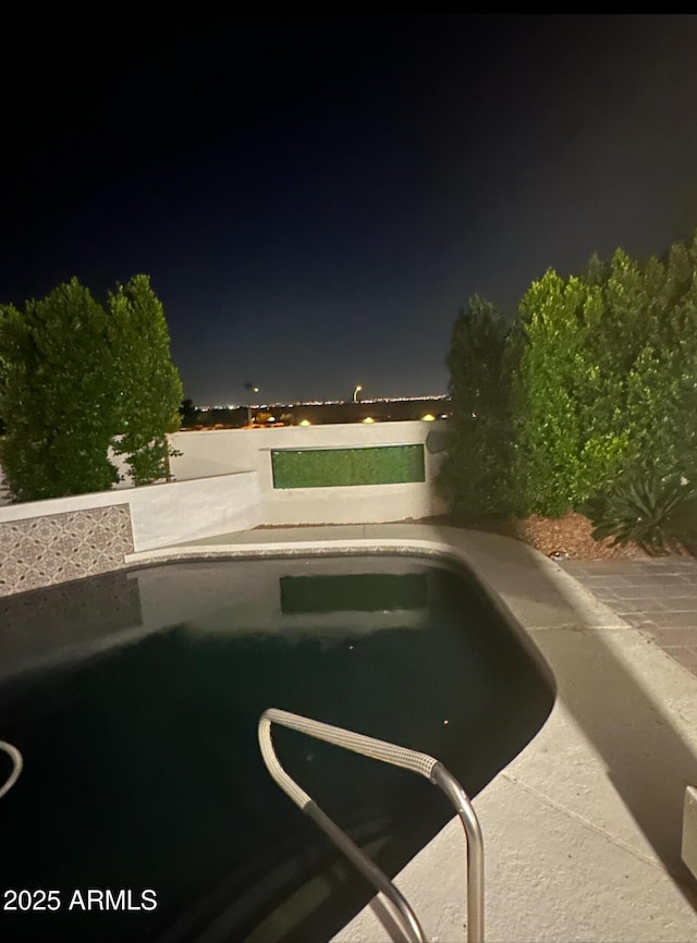 pool at twilight featuring an outdoor pool