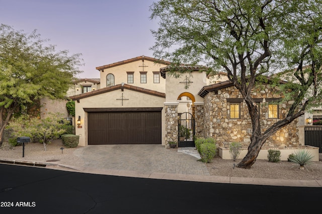 mediterranean / spanish home featuring a garage