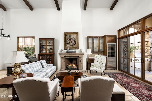 living room with beam ceiling, a healthy amount of sunlight, and french doors