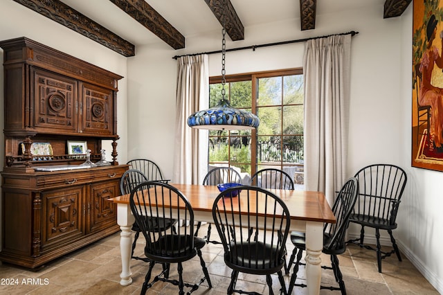 dining space with beam ceiling