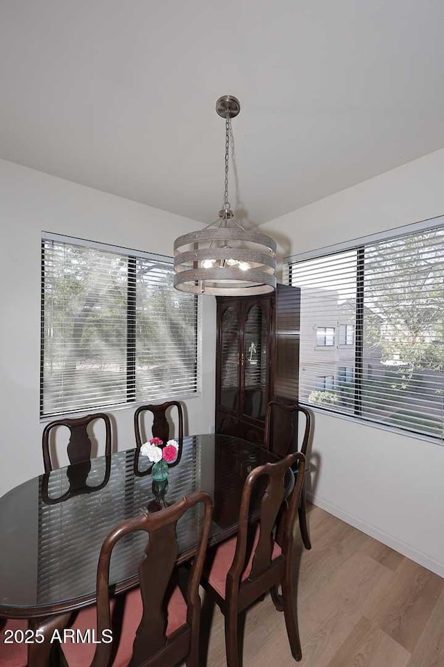 dining space with lofted ceiling, light wood finished floors, and plenty of natural light