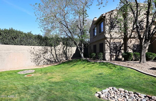 view of yard with a fenced backyard