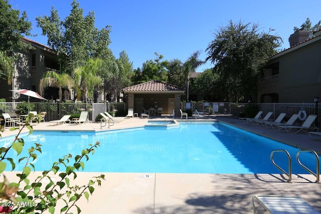 pool with a patio and fence