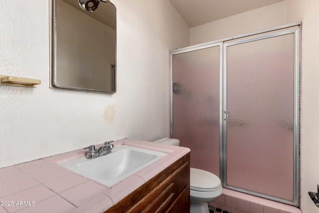 full bath with vanity, a stall shower, and toilet