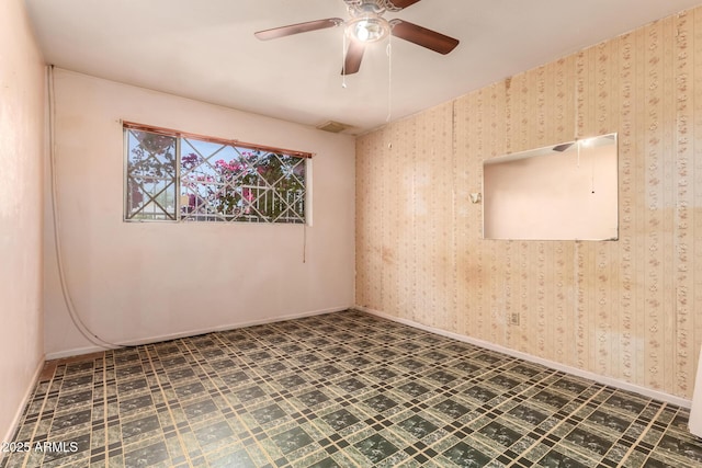 unfurnished room with tile patterned floors, visible vents, baseboards, and ceiling fan