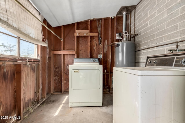laundry area with water heater, washing machine and clothes dryer, and laundry area