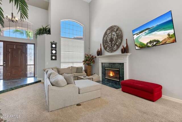 living room featuring built in features, ornamental molding, light hardwood / wood-style floors, and a fireplace