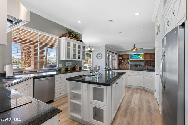 kitchen featuring sink, white cabinetry, a healthy amount of sunlight, and stainless steel dishwasher