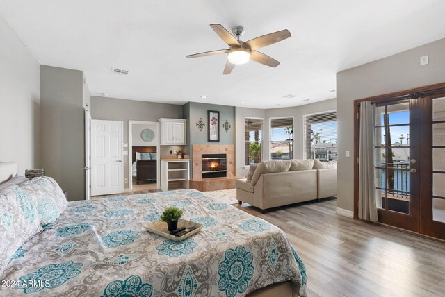 living room with light hardwood / wood-style floors and a high end fireplace