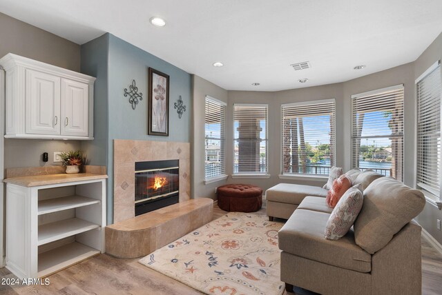 bedroom with ceiling fan, light hardwood / wood-style flooring, access to outside, and french doors