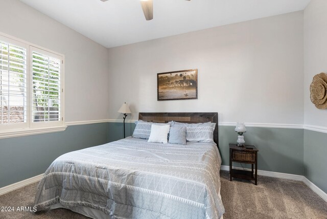 bedroom featuring carpet floors, a walk in closet, and ceiling fan