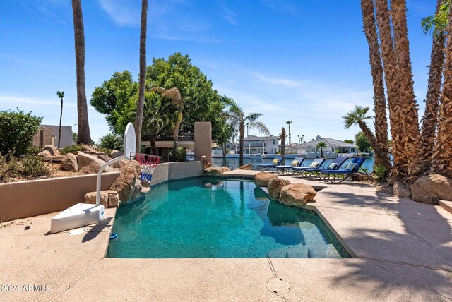 view of swimming pool featuring a water view