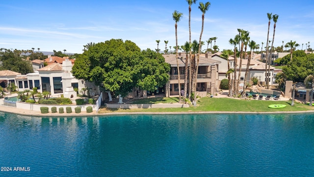 view of swimming pool featuring a lawn and a water view