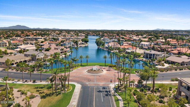 birds eye view of property with a water and mountain view