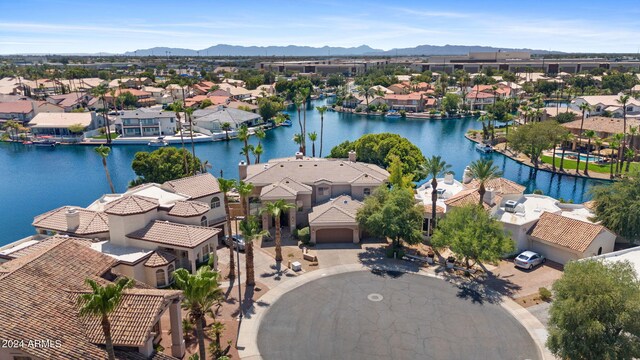 birds eye view of property with a water and mountain view