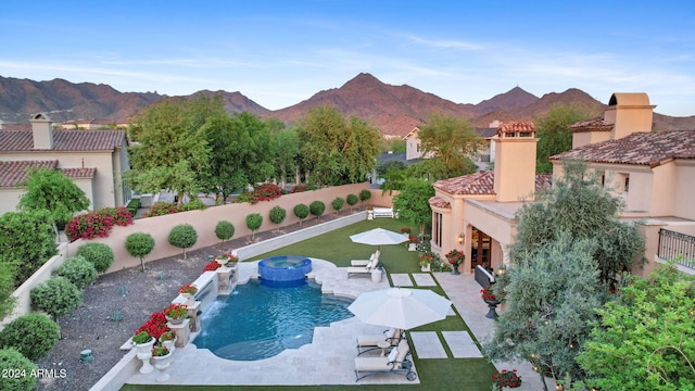 view of pool with a mountain view and a patio area