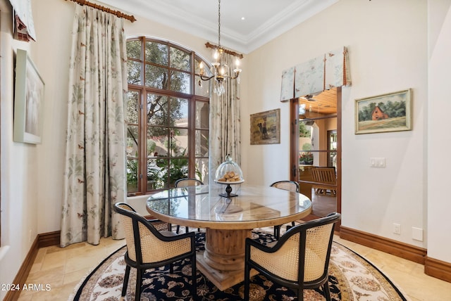 tiled dining space featuring ornamental molding and an inviting chandelier