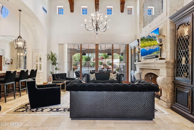 living room featuring a high ceiling, light tile floors, and a chandelier