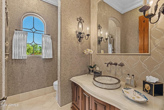 bathroom featuring crown molding, large vanity, and toilet