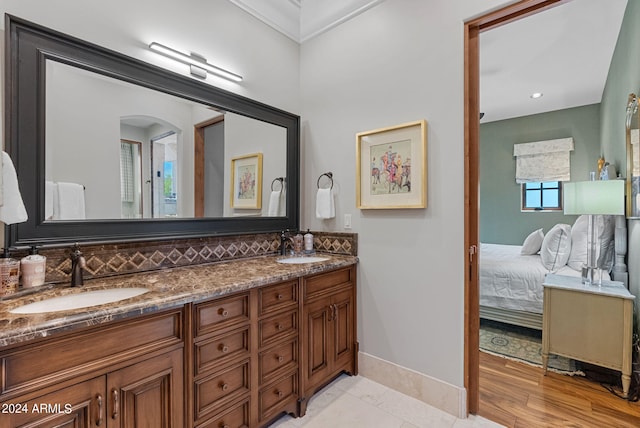 bathroom with tile flooring, tasteful backsplash, and double sink vanity