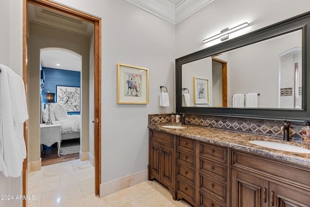 bathroom featuring tile flooring, dual sinks, crown molding, and large vanity