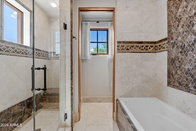 bathroom featuring tile walls, tile floors, and separate shower and tub