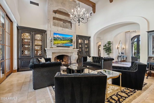 living room with beamed ceiling, a premium fireplace, light tile flooring, and a notable chandelier