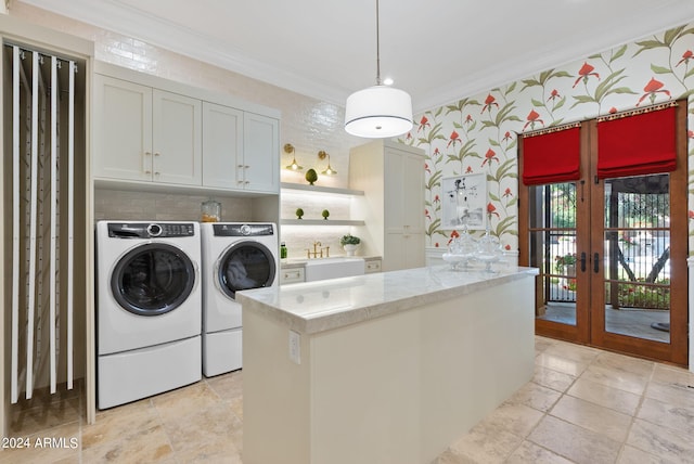 laundry area with washer and dryer, cabinets, french doors, ornamental molding, and light tile floors