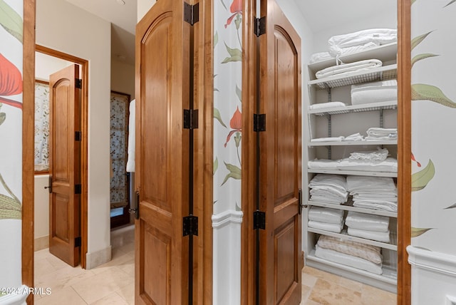 spacious closet with light tile flooring