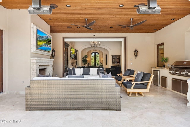 view of patio / terrace featuring an outdoor living space with a fireplace, area for grilling, and ceiling fan